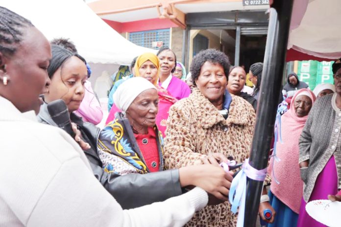Ongata Rongai Muungano Women Groups chair Ruth Wakapa with Eunice Nkopio during handing over of a tent and chairs from NGAAF. Photo Obegi Malack